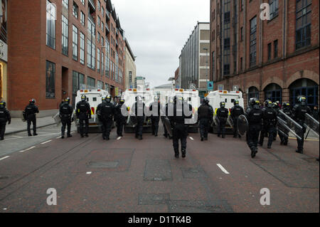 Belfast, UK. 5th Jan, 2013. PSNI officers in Riot gear follow Loyalist protesters as they leave Belfast city center. The ongoing flag protests took place in Belfast after the City Council voted on the 3rd of December 2012 to restrict the flying the Union Jack flag from City hall to 17 days per year, where previously it flew every day of the year. Stock Photo