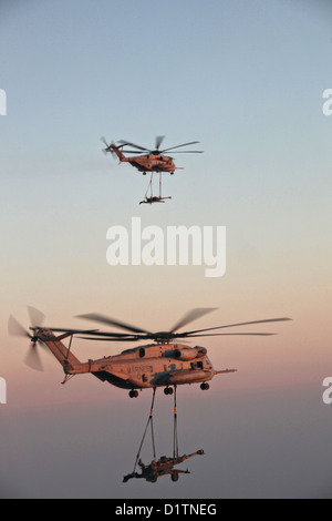 Two US Marine Corps CH-53E Super Stallion helicopters transport M777 towed 155 mm howitzers December 29, 2012 over Helmand province, Afghanistan. Stock Photo
