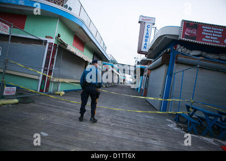 Jan. 5, 2013 - Seaside Heights, New Jersey, U.S - The clean up of the famed boardwalk area continues after its destruction by Hurricane Sandy in Seaside Heights, New Jersey on Saturday, January 5, 2013. A lone State Trooper stands on the boardwalk. (Credit Image: © Nicolaus Czarnecki/ZUMAPRESS.com) Stock Photo