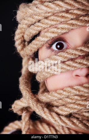 Tied up scared woman face. Violence concept.  Stock Photo