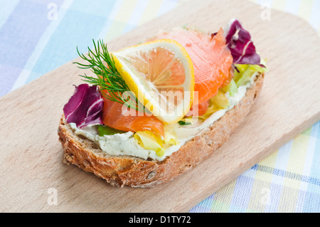 Sandwich with smoked salmon, soft cheese and vegetables Stock Photo