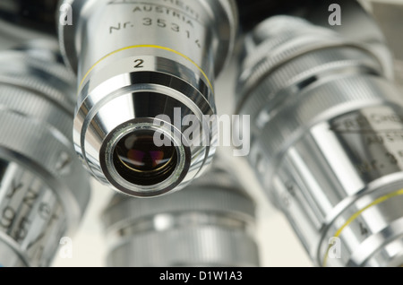 Reichert revolving nosepiece microscope objective four high power magnification lenses phase contrast observe Stock Photo