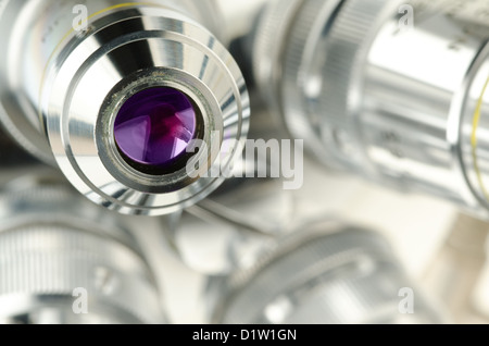 Reichert revolving nosepiece microscope objective four high power magnification lenses phase contrast observe Stock Photo