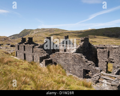 Old ruins of Rhosydd slate quarry quarrymen's barracks with Cnicht mountain in Snowdonia National Park near Croesor Blaenau Ffestiniog Gwynedd Wales U Stock Photo