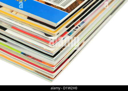 A pile of magazines on a plain white surface Stock Photo