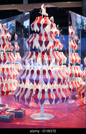 Christmas tree made from Shoes for a Display in a Shop window in London England Stock Photo