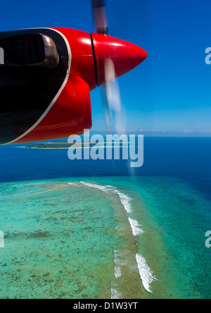 Maldivian Air Taxi Seaplane Flying Over An Atoll, Male, Maldives Stock Photo