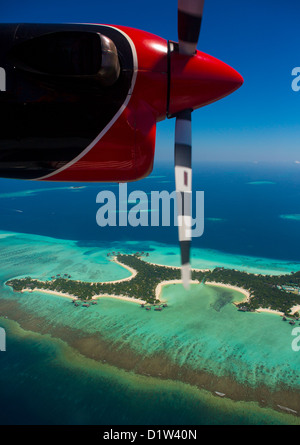 Maldivian Air Taxi Seaplane Flying Over An Atoll, Male, Maldives Stock Photo