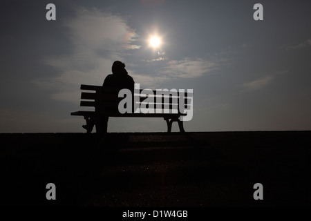 Hanover, silhouette, woman sitting alone on a bench Stock Photo
