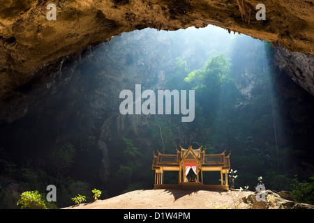 Morning sunbeam on golden buddhist pavillion in wild cave, Sam Roi Yot, Thailand Stock Photo