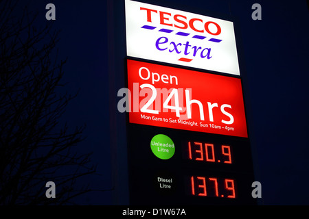 Lit up Tesco store signage situated in the store's carpark. Stock Photo