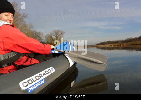 Young woman in Sevylor Colorado Premium inflatable canoe on the River Bure near Horning, Norfolk, Broads National Park Stock Photo