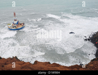 The mobile drilling unit Kulluk grounded in winter storms after breaking free of it tow January 1, 2013 along Sitkalidak Island, Alaska. The Kulluk was floating free after the ship towing it lost power and its tow connection in the Kodiak archipelago. Stock Photo
