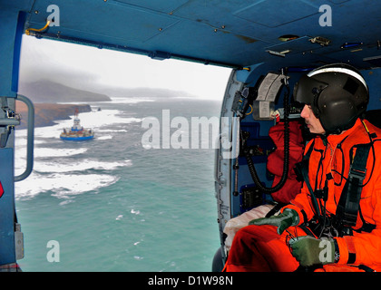 Rear Adm. Thomas Ostebo, commander, 17th Coast Guard District and D17 Incident Management Team commander, conducts an aerial view of the mobile drilling unit Kulluk January 1, 2013 near Sitkalidak Island, Alaska. The Kulluk was floating free after the ship towing it lost power and its tow connection in the Kodiak archipelago. Stock Photo