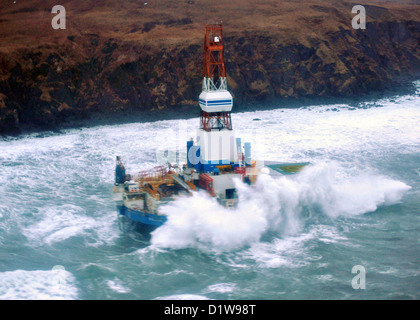 The mobile drilling unit Kulluk grounded in winter storms after breaking free of it tow January 1, 2013, 80 miles southwest of Kodiak City, Alaska. The Kulluk was floating free after the ship towing it lost power and its tow connection in the Kodiak archipelago. Stock Photo