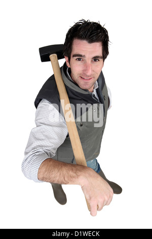 Man carrying sledge-hammer over shoulder Stock Photo - Alamy