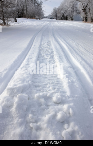 Winter Scene with Snow Icy Tracks on Ground Stock Photo - Alamy