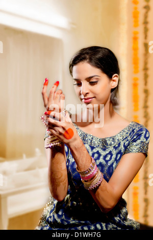 Indian bride wearing bangles Stock Photo