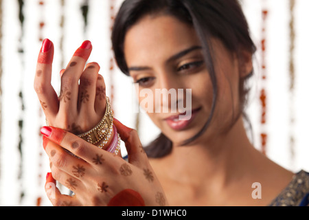 Indian bride wearing bangles Stock Photo