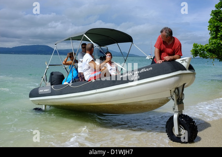 Sealegs an amphibious rigid inflatable boat drives up the beach on an Island near to the Royal Phuket Marina Thailand Stock Photo