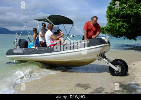 Sealegs an amphibious rigid inflatable boat drives up the beach on an Island near to the Royal Phuket Marina Thailand Stock Photo