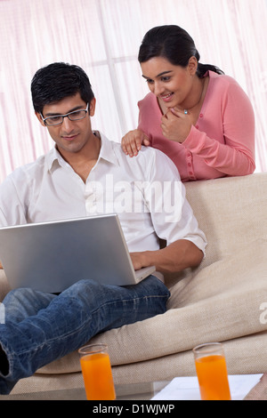 Young couple using laptop at home Stock Photo