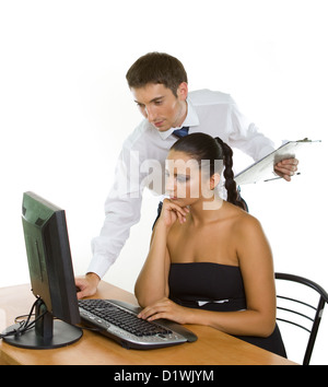 Two contemporary businesspeople discussing while working at the computer Stock Photo