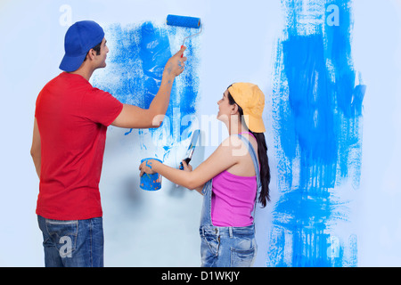 Young couple painting wall Stock Photo