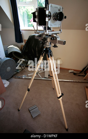 A large format film camera on a wooden tripod. Stock Photo