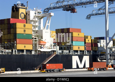 Container ship being loaded at Rotterdam sea port. Stock Photo