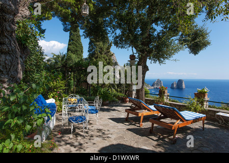 Garden terrace overlooking the Faraglioni on the Isle of Capri. Campania, Italy. Stock Photo