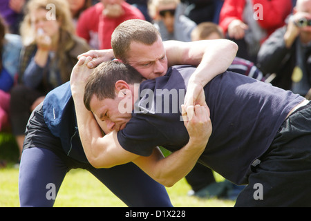 Cumberland & Westmorland Wrestlers in clinch, with crowd behind at Grasmere Lakeland Sports,Lake District National Park,Cumbria, Stock Photo