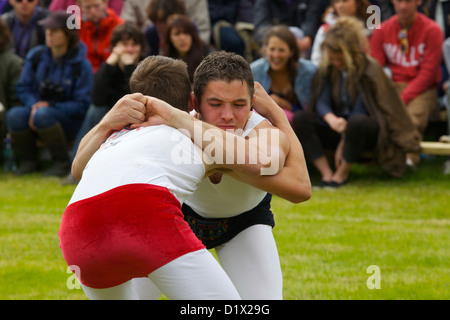 Cumberland & Westmorland Wrestlers in clinch, with crowd behind at Grasmere Lakeland Sports,Lake District National Park,Cumbria, Stock Photo