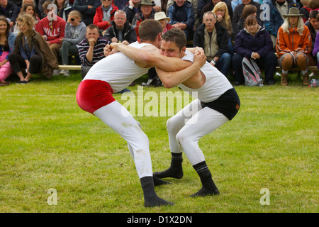 Cumberland & Westmorland Wrestlers in clinch, with crowd behind at Grasmere Lakeland Sports,Lake District National Park,Cumbria, Stock Photo