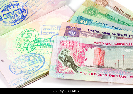 UAE holiday travel money currency and visa stamps in a passport for Dubai and Abu Dhabi Stock Photo