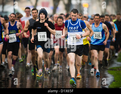 Amateur runners competing in a 10k road race in the rain, Aberystwyth Wales UK Stock Photo