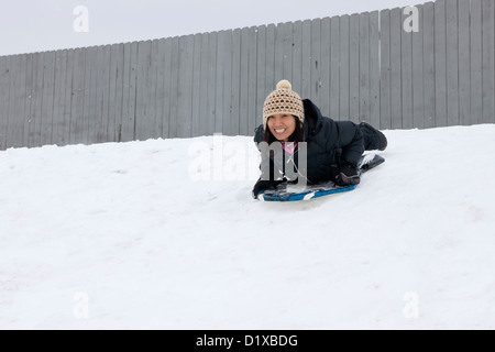Woman slides down hill. Stock Photo