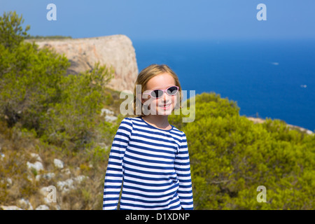 child kid girl in mediterranean sea with summer sailor blue stripes Stock Photo