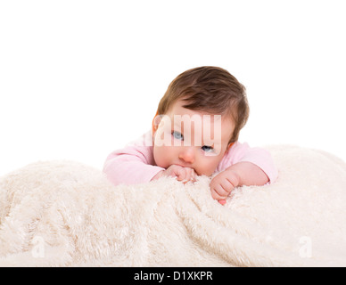 baby girl with toothache in pink with winter white fur background Stock Photo