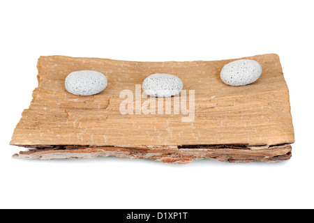 three stones on a grunge wood isolated on white background Stock Photo