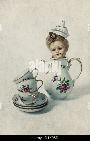 three vintage cups and a tea pot with the head of an old victorian doll