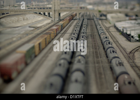 Cargo and containers stationery on a rail track, by the side of the L.A. River, California, USA Stock Photo