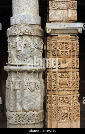 Carved pillars in cloister of Quwwat UI Islam Mosque in the Qutb Minar complex in Delhi, India Stock Photo