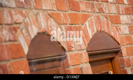 Close up view of brick arches over windows on a newly converted barn in the English countryside. Stock Photo