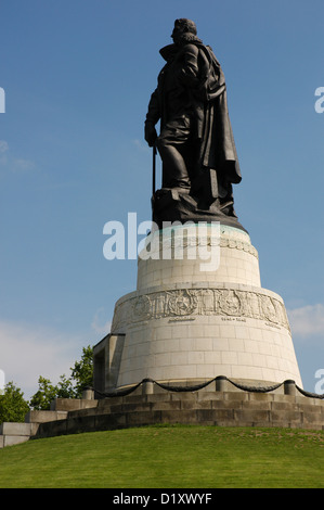 Soviet War Memorial (1949). Nikolai Masalov monument. Statue of a Soviet soldier with a child as he crushes a Swastika. Berlin. Stock Photo