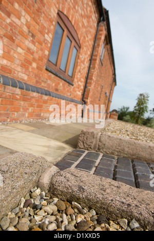 Close up exterior shot of newly laid path outside a smart barn conversion in the English countryside. Stock Photo