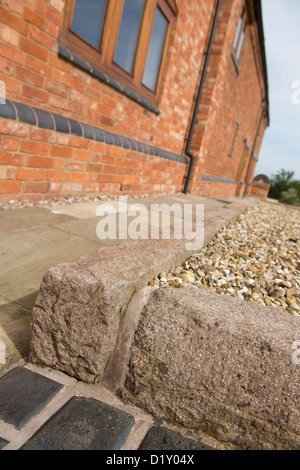 Close up exterior shot of newly laid path outside a smart barn conversion in the English countryside. Stock Photo
