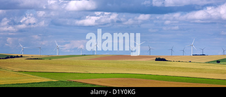 Rural landscape with wind turbines of wind farm amongst fields Stock Photo