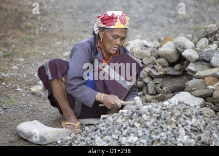 Woman crushing stones. Tawang, Arunachal Pradesh, India. Stock Photo