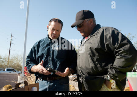 Jan. 8, 2013 - Tucson, Arizona, U.S - FRANK ANTENORI, a former GOP candidate for the US House and state legislator, left, speaks with HAROLD LEWIS, right, a gun owner hoping to sell his 9mm pistol for $350 in lieu of a $50 grocery store gift card.  Antenori announced he'd be buying guns he liked on the sidewalk adjacent to a buyback event held at a police station. (Credit Image: © Will Seberger/ZUMAPRESS.com) Stock Photo